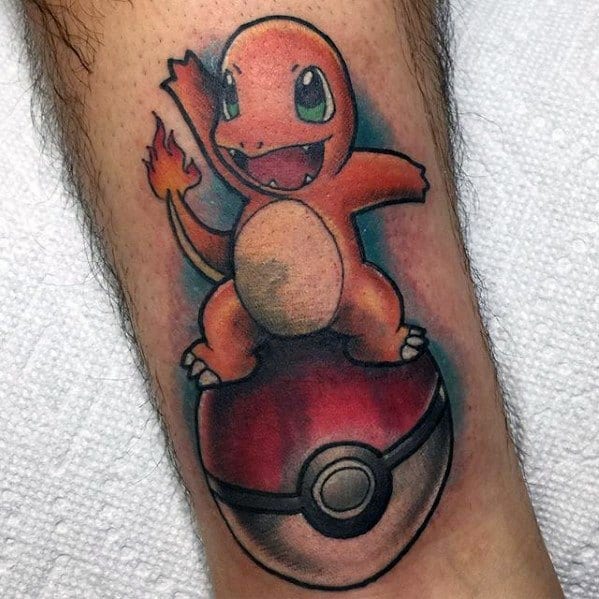 Playful Charmander tattoo standing on a Pokeball with bright colors, cartoonish style, and bold outlines on the lower leg.