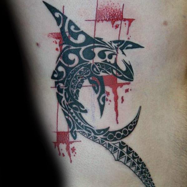 Polynesian shark tattoo with red splatter background, featuring bold tribal patterns symbolizing warrior spirit, power, and ocean protection.