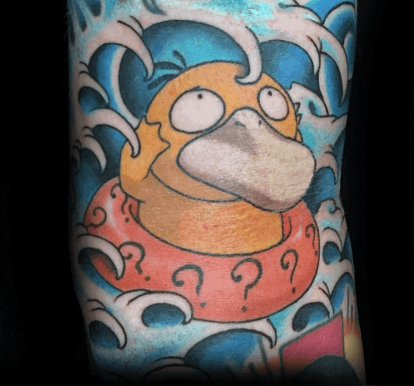 Confused Psyduck tattoo floating in stylized blue waves with a red swim ring covered in question marks, on a man's arm.
