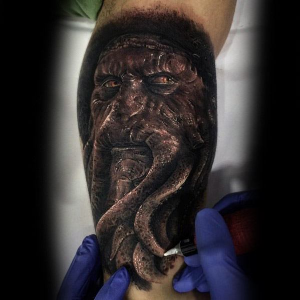 Dark and lifelike Davy Jones tattoo, showcasing his tentacled face, piercing eyes, and intricate details