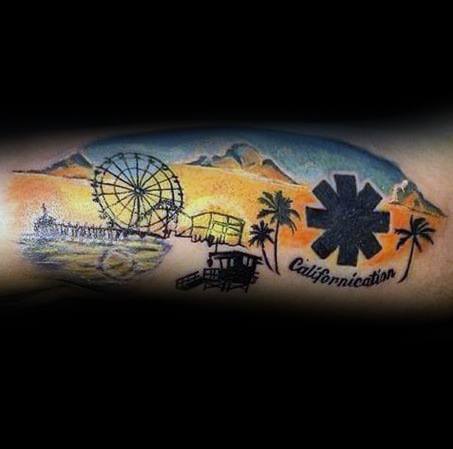 Tattoo featuring a scenic California landscape with a Ferris wheel, mountains, and palm trees, alongside the Red Hot Chili Peppers logo and "Californication" text.