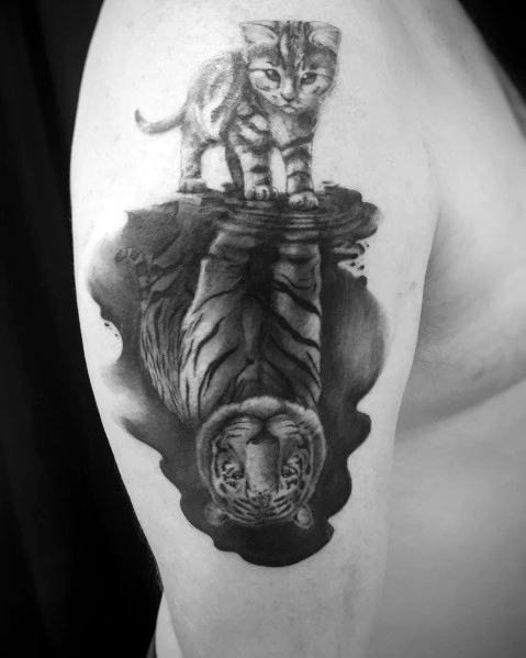 Tattoo of a kitten looking into water, reflecting the image of a tiger, symbolizing inner strength and transformation with a surreal effect.