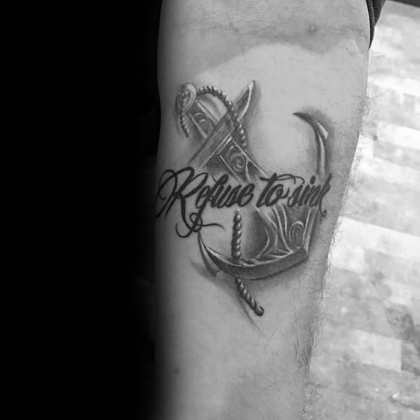Anchor tattoo with "Refuse to Sink" etched on an arm
