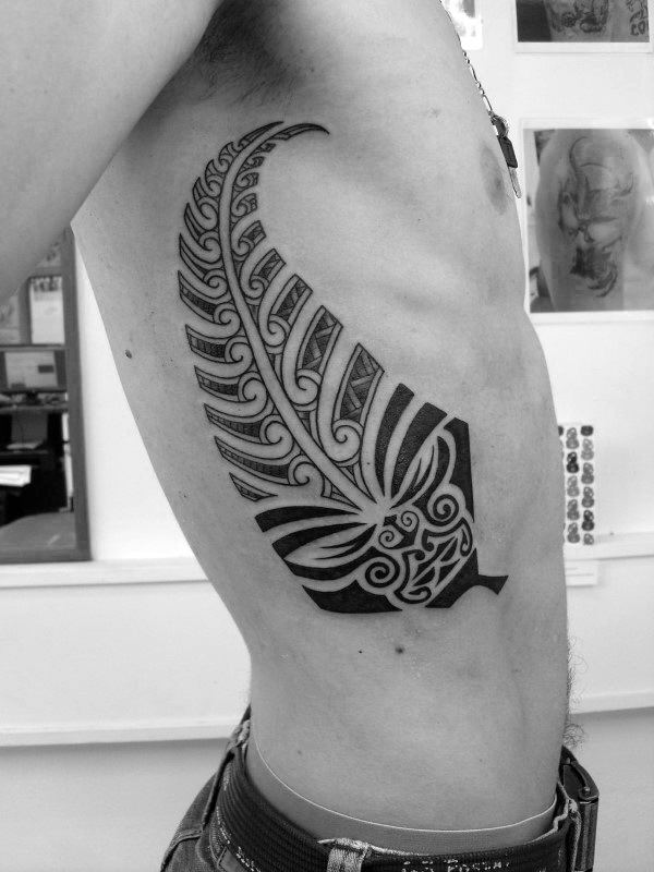 Mens Rib Cage Side Tribal Fern With Figure Face Tattoo Design