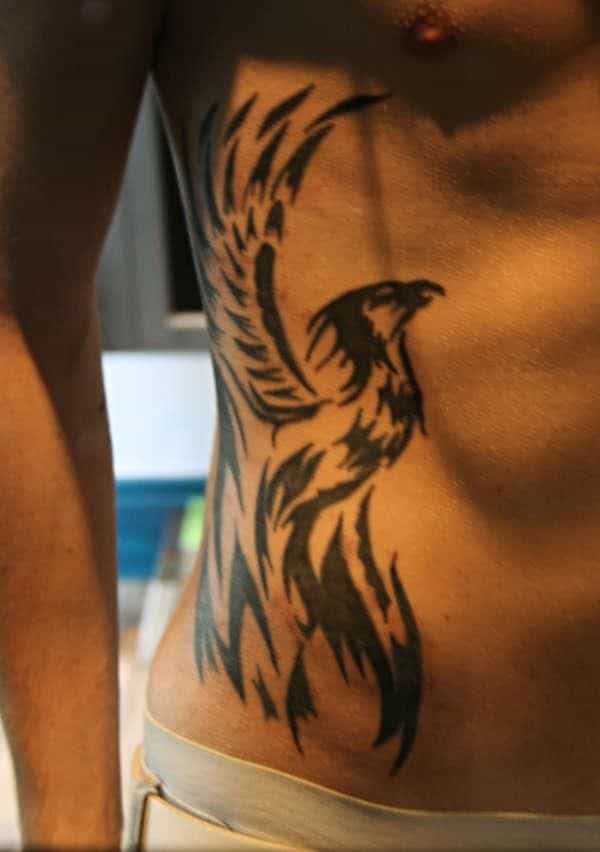 Phoenix tattoo on a person's side torso