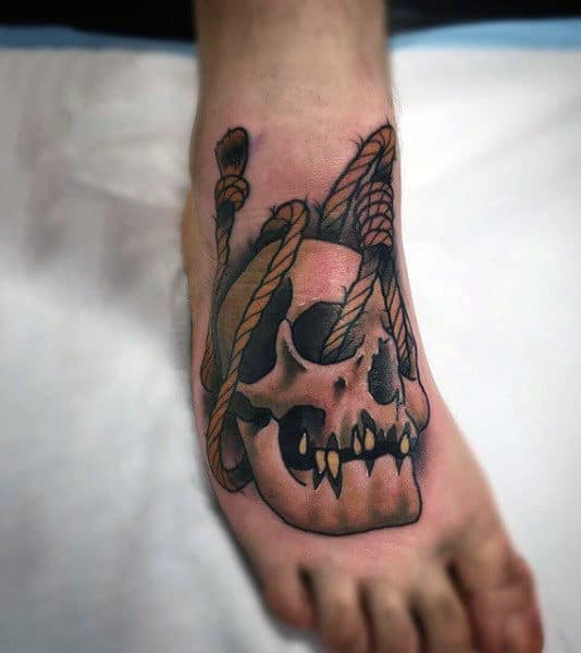 A foot tattoo of a skull entangled in ropes, featuring an artistic blend of dark and vibrant colors