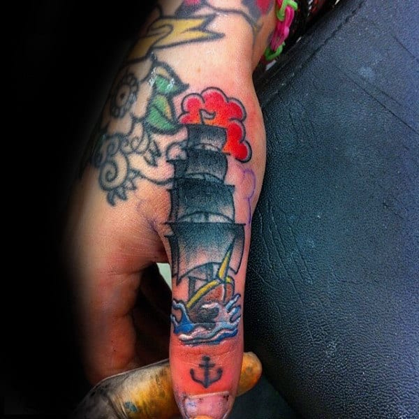 Mens Sailing Ship With Small Anchor Thumb Tattoo