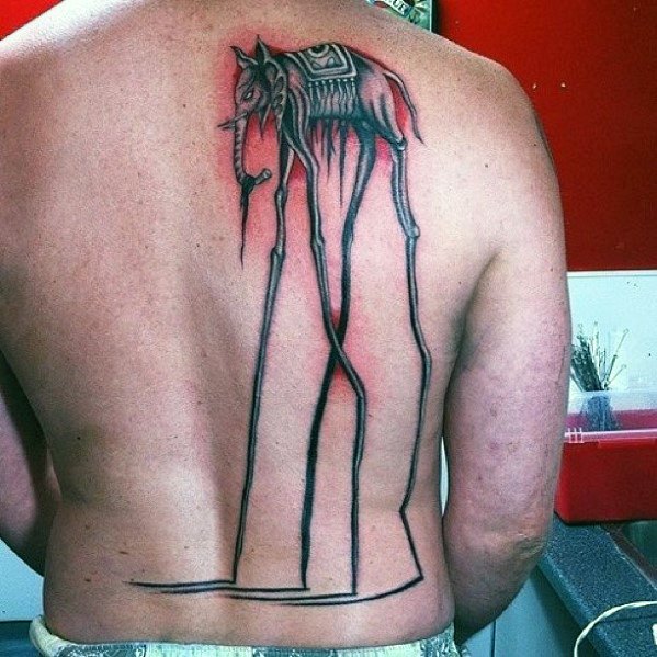 Large Salvador Dali-inspired back tattoo of a surreal elephant with elongated legs and dripping details, walking down the spine toward the lower back.