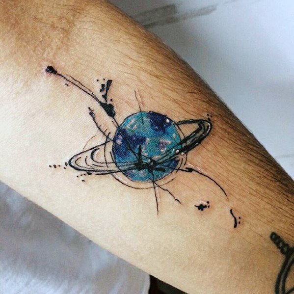 Watercolor Saturn tattoo design for men featuring a blue planet with abstract black ink splashes and orbiting ring details.