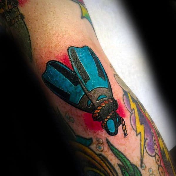 Colorful traditional-style tattoo of blue scuba diving fins tied together with rope, set against a bold red background.