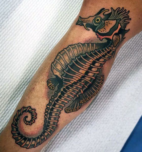 Neo-traditional seahorse skeleton tattoo on forearm, featuring bold outlines, rich shading, and intricate bone details for a striking design.