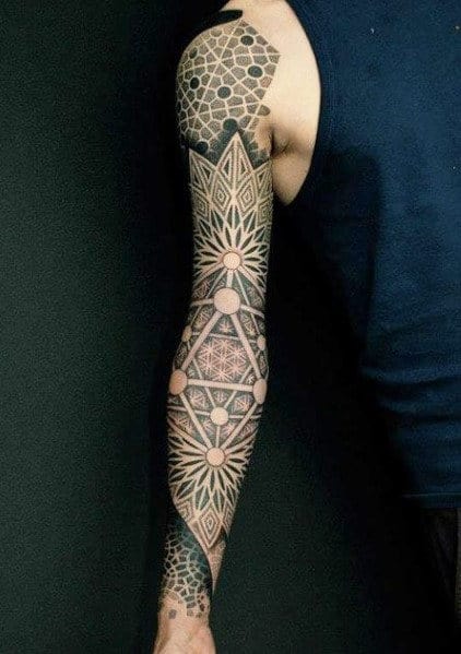 Intricate geometric tattoo sleeve on a person's arm with detailed patterns