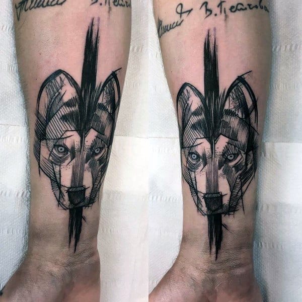 Abstract Siberian Husky tattoo on a man's forearm, featuring bold sketch-style lines and a vertical black ink streak for a modern look.
