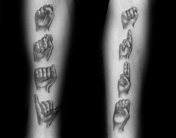 realistic black and grey tattoo of hands spelling out a word in American Sign Language, placed vertically along both forearms