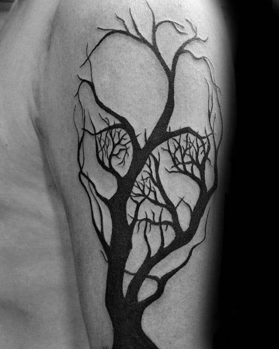 Abstract tree tattoo with thick black trunk and intertwining branches subtly forming a hidden skull within the negative space.