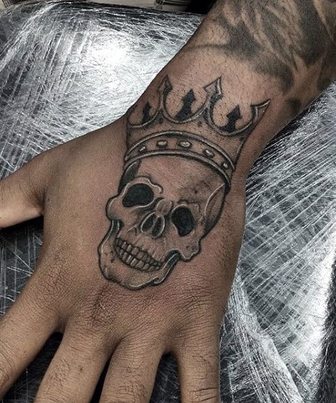 Mens Small Skull With Crown Hand Tattoo