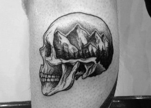 mens-small-skull-with-mountain-landscape-leg-tattoo-1