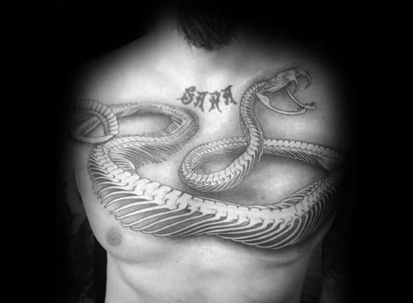 Snake skeleton tattoo across the chest, featuring a detailed ribcage and skull with bold shading for a striking and dynamic design.