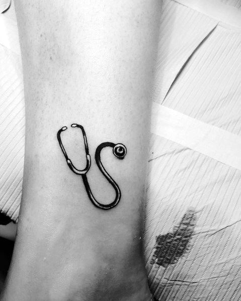 Minimalist stethoscope tattoo on the wrist, symbolizing a deep commitment to the medical field and a passion for healthcare.