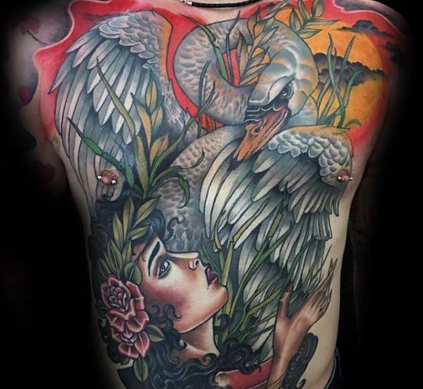 Vibrant full torso tattoo of a swan and a woman surrounded by flowers and reeds, set against a fiery sunset in a neo-traditional style.