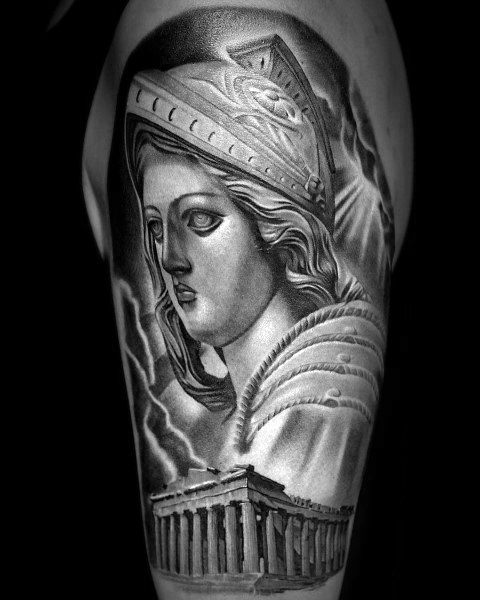 Black and grey Athena tattoo with classical statue features, detailed helmet, and Parthenon temple below on upper arm