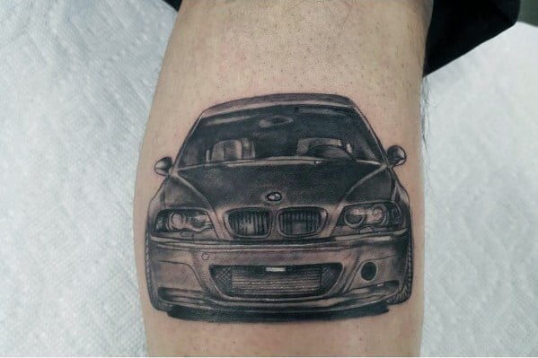 Realistic BMW E46 M3 tattoo on leg, featuring detailed shading and a bold front-end view for a striking automotive-inspired design.