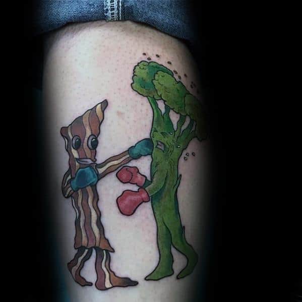 Cartoon-style tattoo of a broccoli and bacon strip boxing, featuring bold outlines and vibrant colors for a fun and playful design.