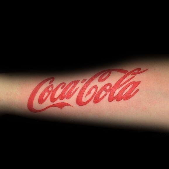 Bold Coca-Cola logo tattoo in vibrant red ink on the forearm, featuring clean lettering and a classic design for a sleek and iconic look.