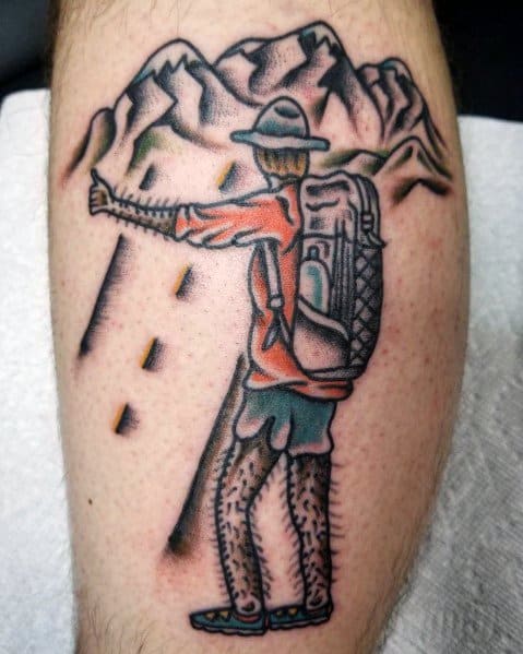 Colorful tattoo of a backpacker hitchhiking toward the mountains, symbolizing adventure, wanderlust, and the spirit of exploration.