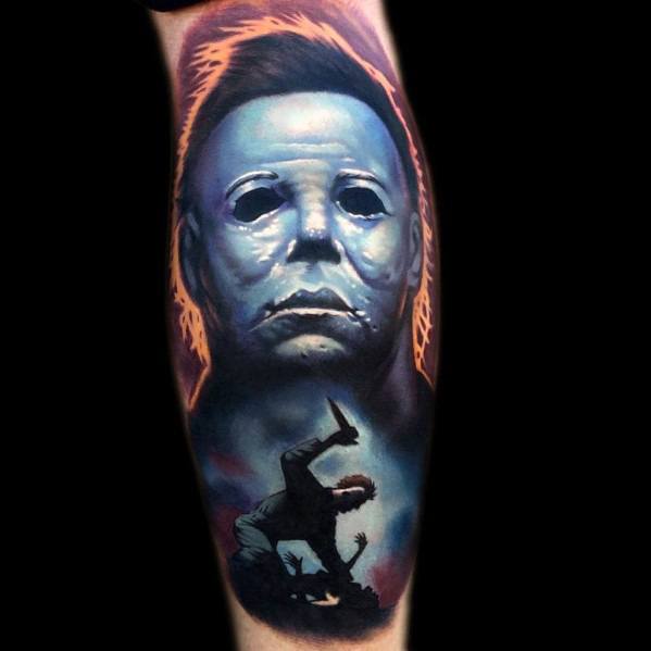 Vivid Michael Myers tattoo with a glowing aura, his eerie mask, and a dynamic horror scene silhouette for a striking design.