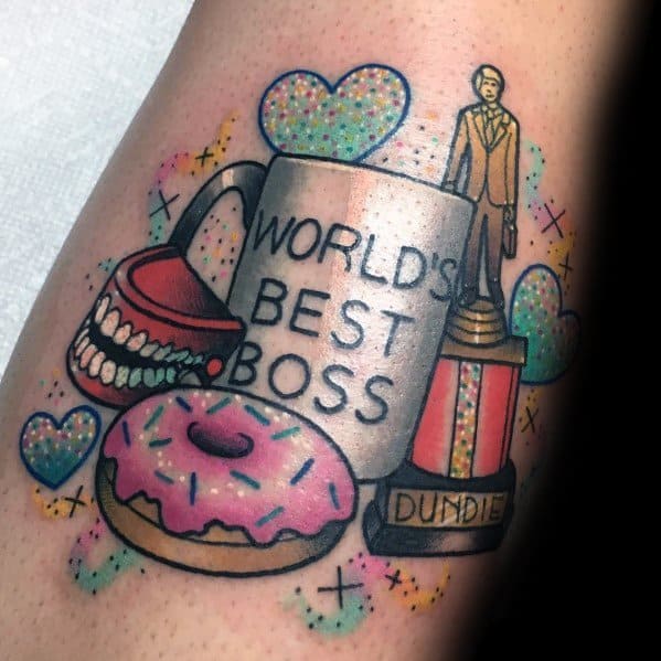 Color tattoo featuring *The Office* references, including Michael Scott’s "World’s Best Boss" mug, a Dundie Award, a pink-frosted donut, chattering teeth, and sparkly hearts.