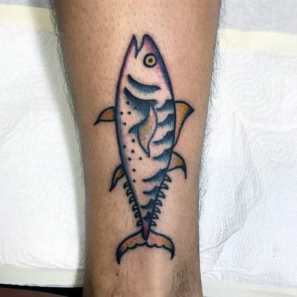 Traditional-style tuna fish skeleton tattoo on a man's leg, featuring bold outlines, vibrant shading, and a vintage nautical aesthetic.