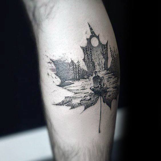 Blackwork tattoo of a maple leaf silhouette containing a forest, full moon, and a seated figure in nature, symbolizing solitude and reflection.