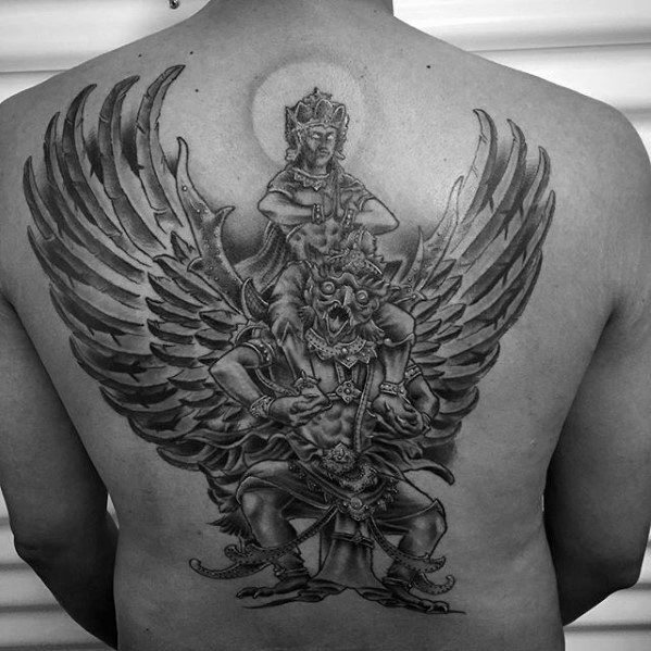 Full back Garuda tattoo in black and grey, showing a majestic winged figure carrying a deity with detailed shading and a radiant halo.
