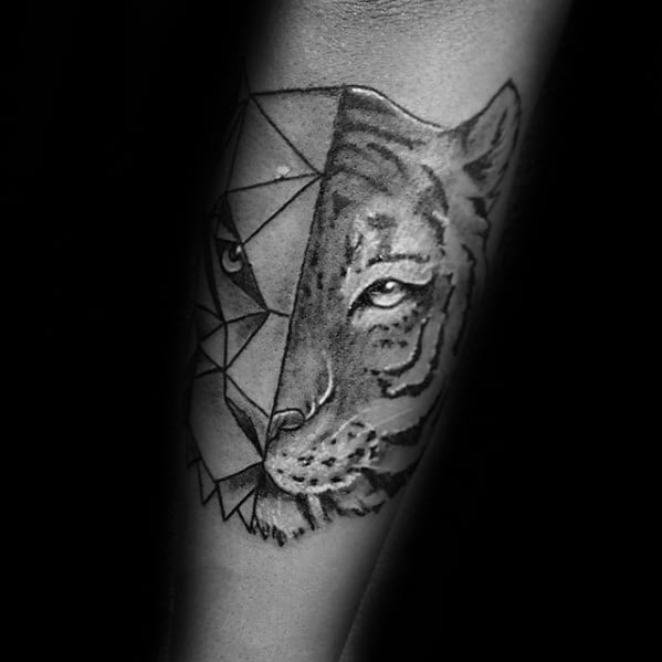 Forearm tattoo of a tiger face split into geometric lines and realistic shading, symbolizing a fusion of strength and structure.