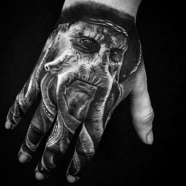 Tattoo of a detailed, mythical Davy Jones face on a hand, black and white