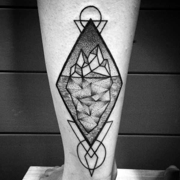 Geometric iceberg tattoo with dotwork shading, set inside a diamond frame with intersecting circles and triangles above and below.