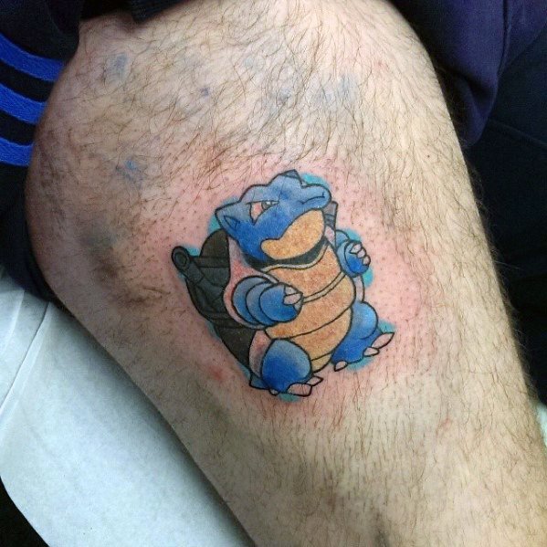 Small and vibrant Blastoise tattoo with a playful pose and soft red shading, placed on the upper thigh for a fun pop of color.