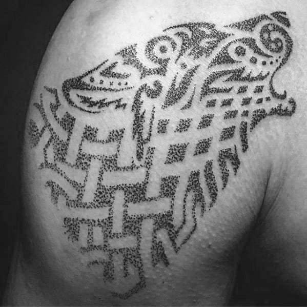 Dotwork Celtic wolf tattoo on shoulder with woven knot patterns and a stylized wolf head created using detailed stippling technique.