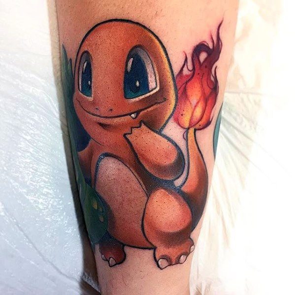 Adorable Charmander tattoo with big sparkling eyes, warm orange tones, and a softly glowing flame on its tail, placed on the calf.
