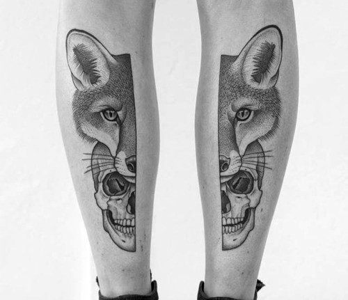 Matching calf tattoos of a fox face merging with a human skull, rendered in fine dotwork with strong symmetry and shading.