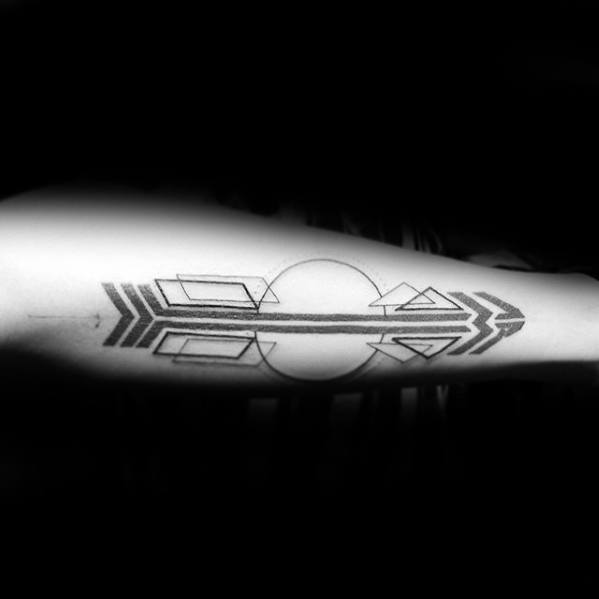 Bold geometric arrow tattoo with mirrored lines, circles, and shapes like squares and triangles forming a symmetrical design on the forearm.