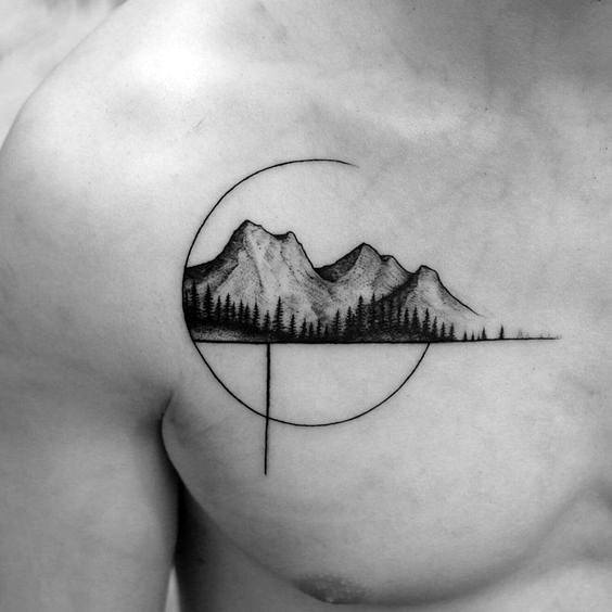 Chest tattoo of a mountain and pine tree landscape framed by a minimalist open circle with intersecting vertical and horizontal lines.