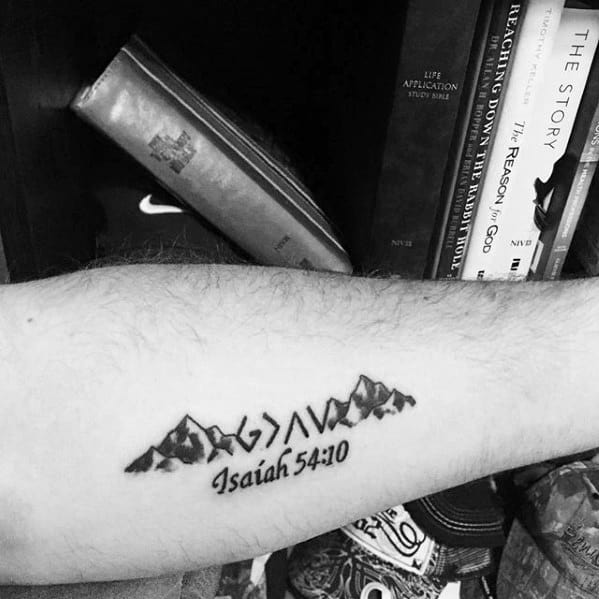 Faith-inspired tattoo with 'God is greater than highs and lows,' mountains, and Isaiah 54:10 scripture