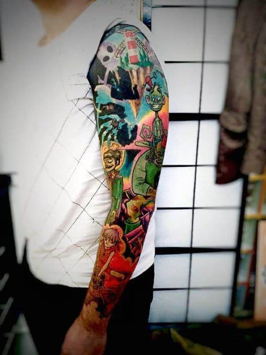 Full-sleeve color tattoo featuring Gorillaz characters and scenes, packed with vibrant detail, layered imagery, and a bold comic-style aesthetic.