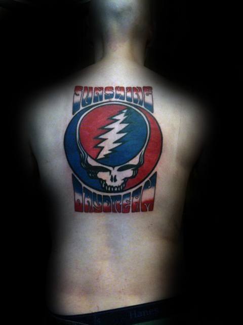 Grateful Dead back tattoo featuring the Steal Your Face skull logo in red and blue with the words “Sunshine Daydream” above and below.