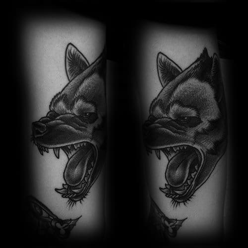 Black and grey hyena tattoo with smooth dotwork shading, capturing a snarling expression and fierce open mouth in a clean, stylized design.