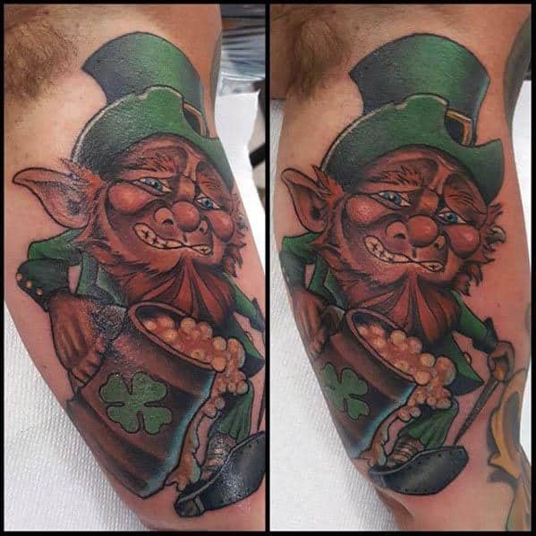 Colorful leprechaun tattoo with a mischievous grin, holding a mug overflowing with beer and a green outfit adorned with shamrocks.