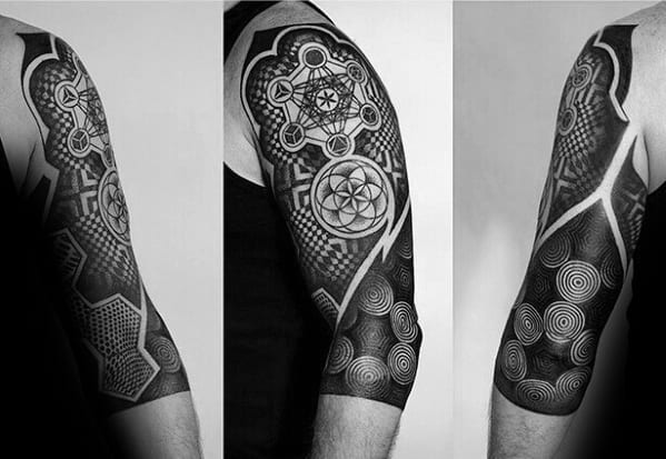 Full upper arm Metatron’s Cube tattoo with bold blackwork, dotwork shading, and intricate sacred patterns like the Flower of Life and spirals.