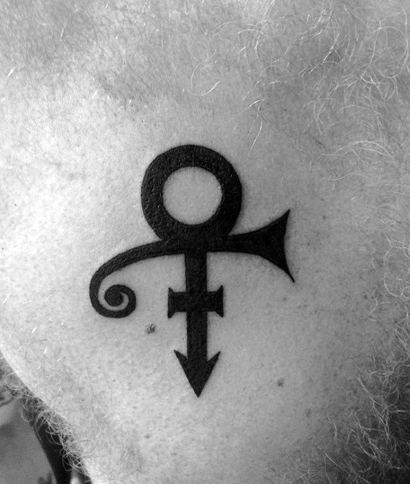 A black tattoo of Prince's Love Symbol on skin, featuring a combination of male and female symbols